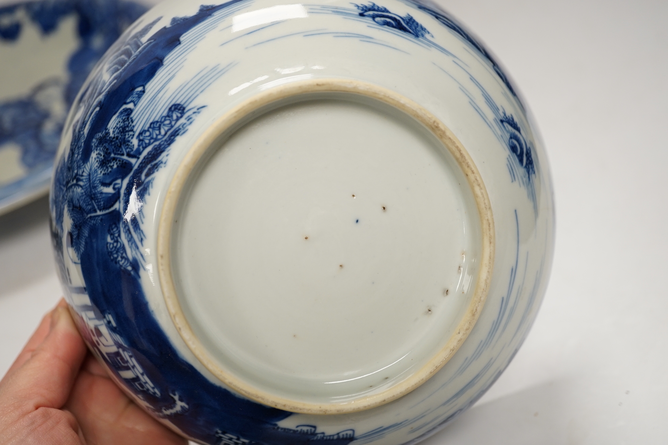 Assorted Chinese and Japanese ceramics comprising a famille rose bowl, two blue and white plates and a blue and white bowl, largest 30cm in diameter